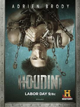 Poster of a show featuring a man upside down, bound in chains, with the text "Adrien Brody" and "Houdini." It airs on Labor Day at 9/8c on History channel.