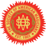 Emblem of The Society of American Magicians, featuring a red and yellow circular design with a snake and a stylized "M" at the center. Established 1902.