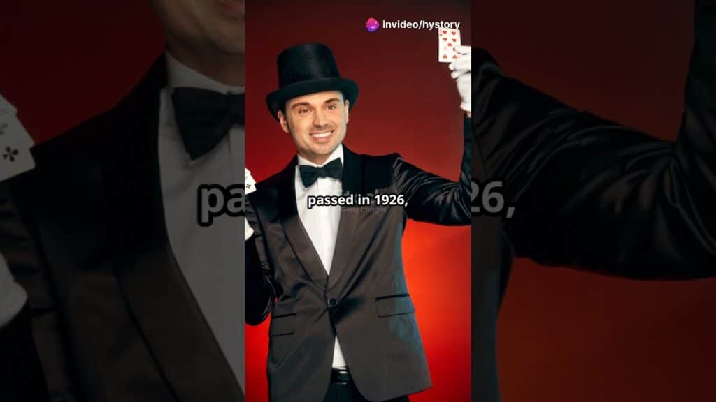 A magician in a tuxedo and top hat holds playing cards, smiling against a red background.