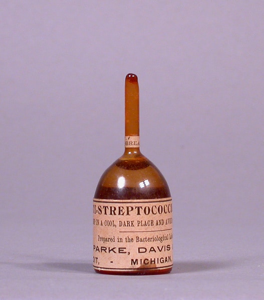 Small glass vial labeled "Anti-Streptococcus" with a brown liquid inside, manufactured by Parke, Davis & Co., Detroit, Michigan.