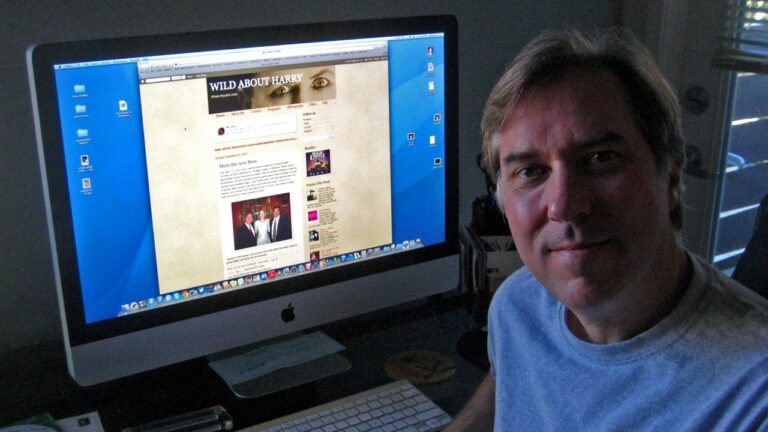 A person sits at a desk in front of a large iMac displaying a blog titled "Wild About Harry.